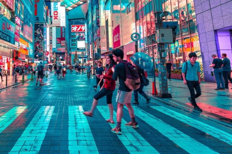 How Accessible Is Japan For Blind Or Visually Impaired Travelers? Young man helping a woman cross the street in Japan