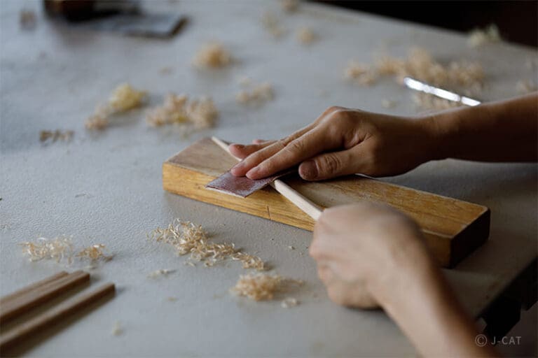 Best Chopstick Workshops in Japan: Tokyo and Kyoto Hands of a person making chopstick in a chopstick-making workshop in Tokyo