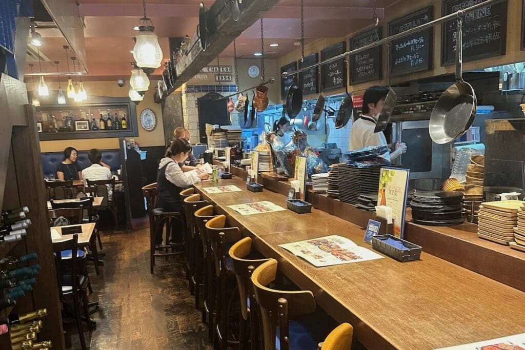 woman seating at the counter of a Japanese restuarant in Tokyo