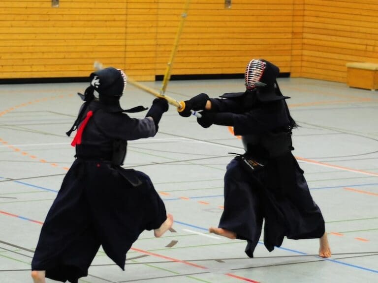 What Is Kendo? Best Kendo Experiences in Tokyo and Kyoto two kendo practitioners fighting in a gymnasium
