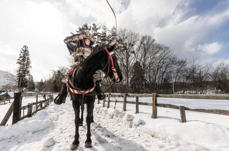 Yabusame in Japan: Best Experiences, Prices, and What to Expect Samurai on a horse in the snow shooting an arrow to show yabusame, horseback archery