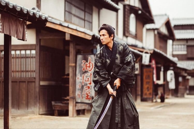 Japanese samurai with sword in hands in a street in old Japan 