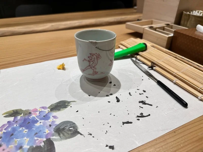 Broken pottery glued back together with putty to fill empty holes