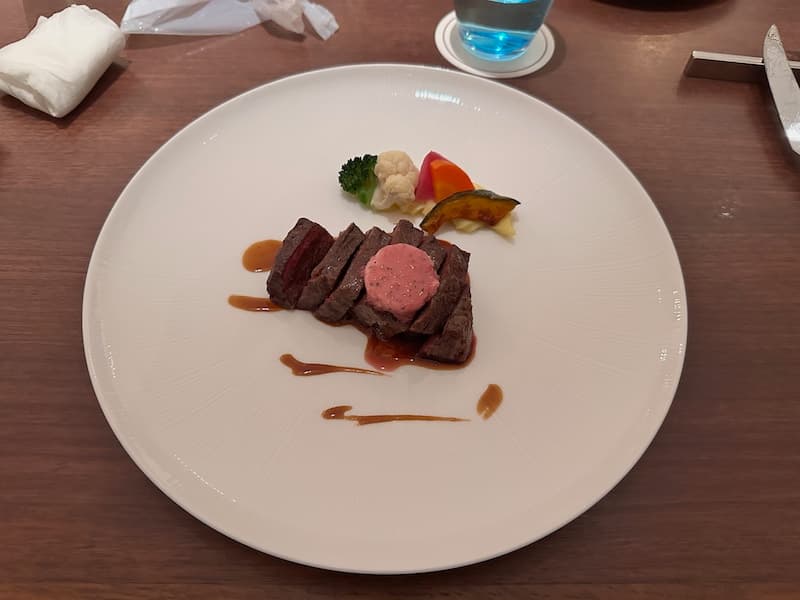 A plate of steak with vegetables and sauce served at the Prince Hotel restaurant in Oiso.