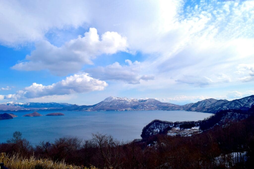 Wide view of Lake Tōya with snow-capped mountains in Hokkaido