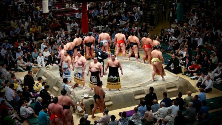Sumo wrestlers entering the ring during a tournament at Ryogoku Kokugikan in Tokyo