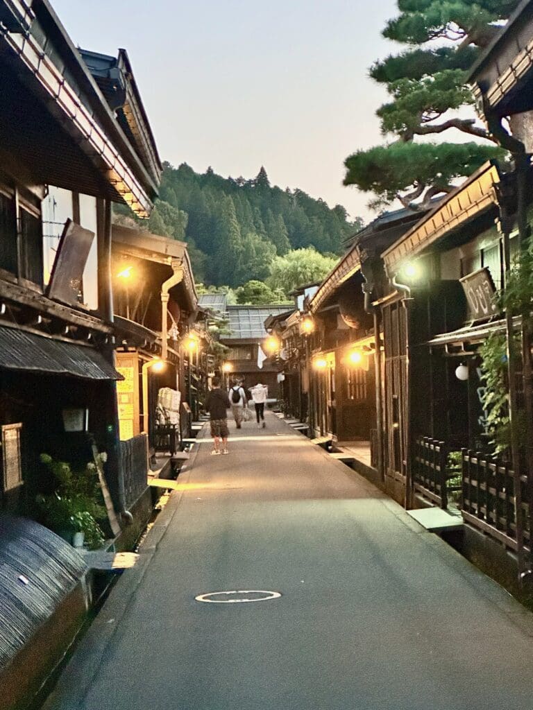 Traditional wooden merchant street in Sanmachi, Takayama, Japan at dusk