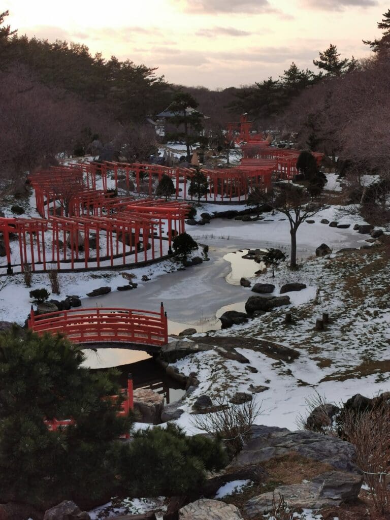 Red torii gates and bridges at Takayama Inari Shrine in winter, Tsugaru, Aomori, Japan