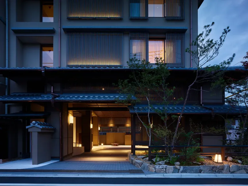 The Celestine Kyoto Gion hotel entrance at dusk with warm lights and a traditional-style facade