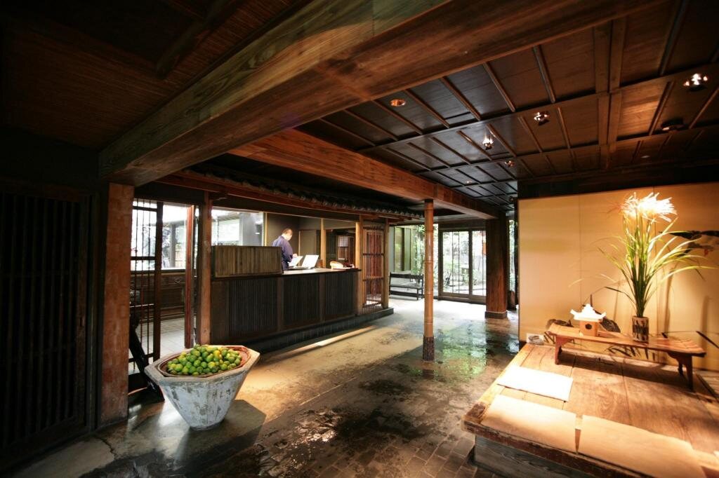 Traditional interior of Yuzuya Ryokan in Kyoto with a wooden reception area and tatami seating
