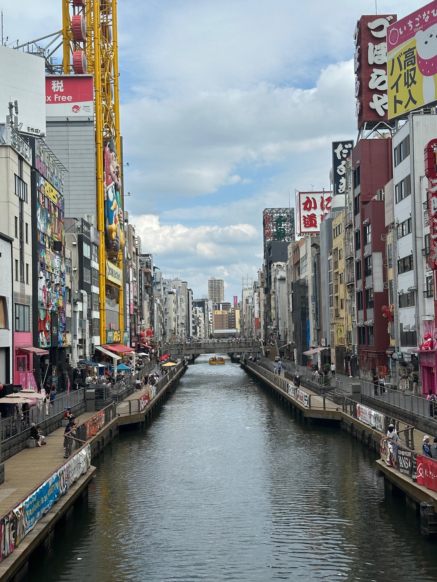 Dotonbori Canal in Osaka with shops and colorful signs along both banks