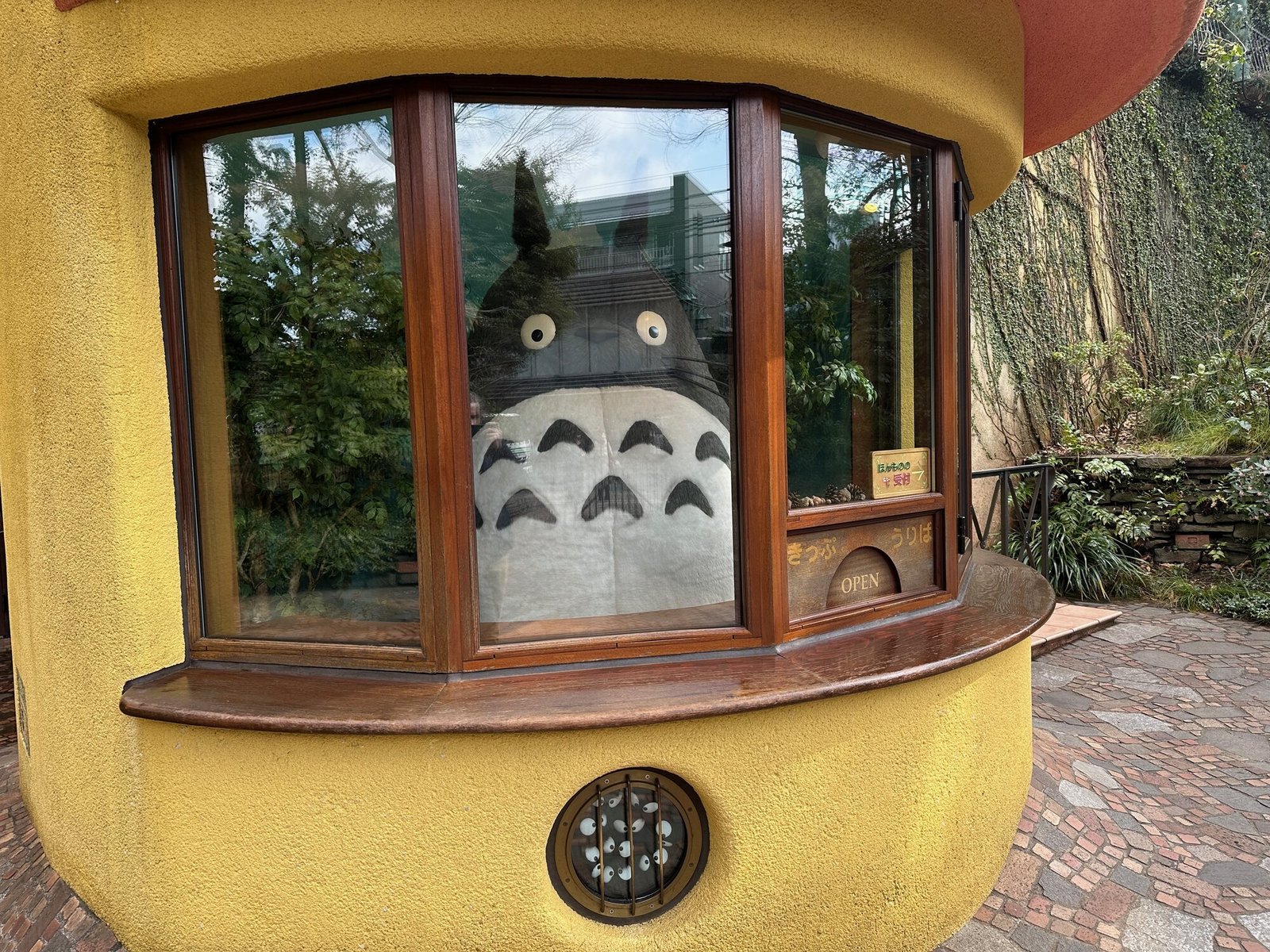Totoro figure in a wooden window at the Ghibli Museum in Mitaka, Tokyo